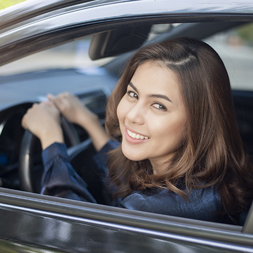 Close up of woman driving her EV