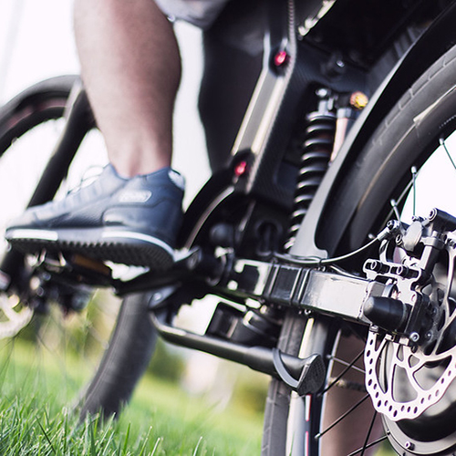 Close up of electric bike gears wtih man legs in view.