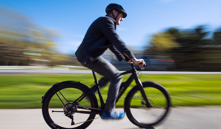 Man riding electric bike in the spring on a sunny day.