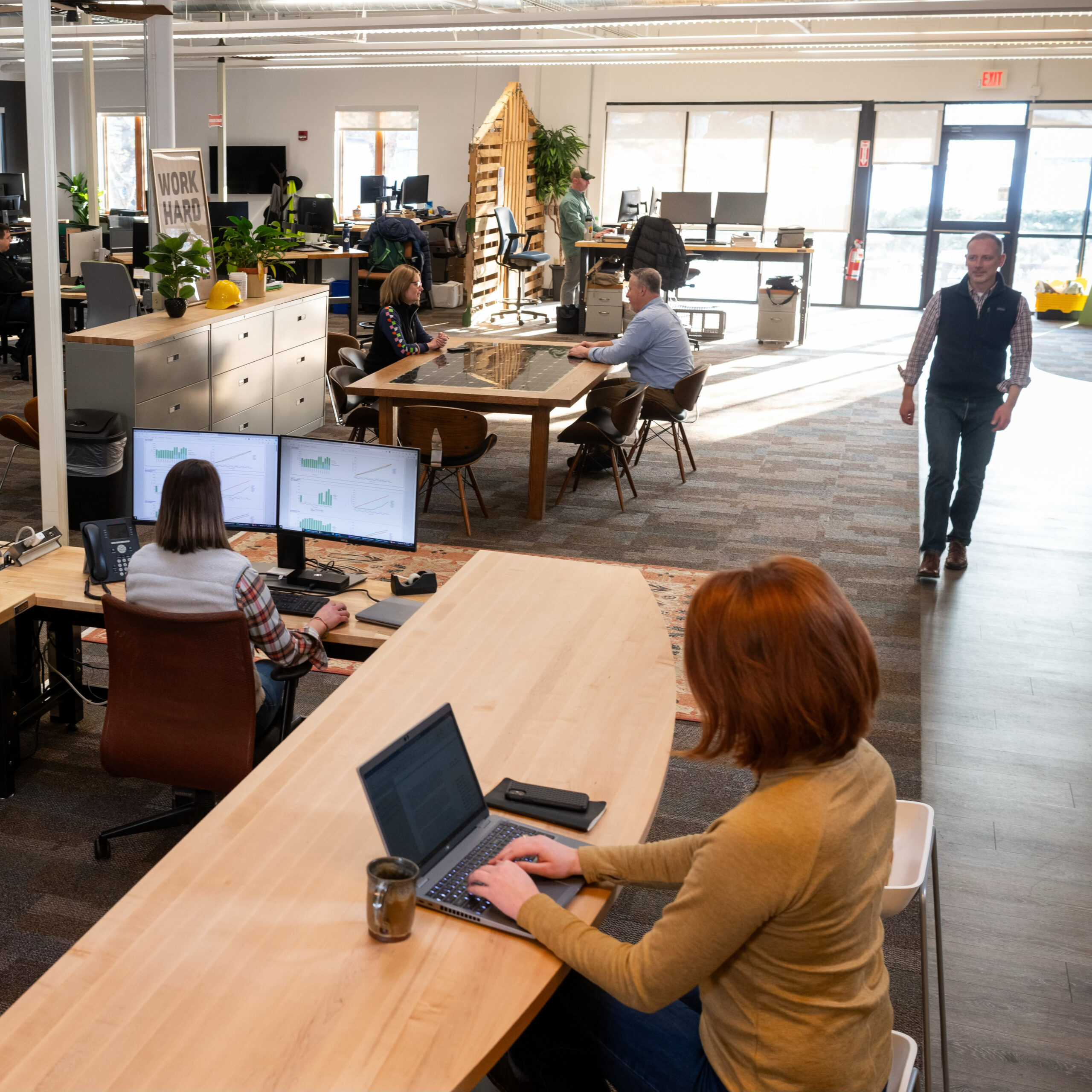 Employees in the GMP office working at desks